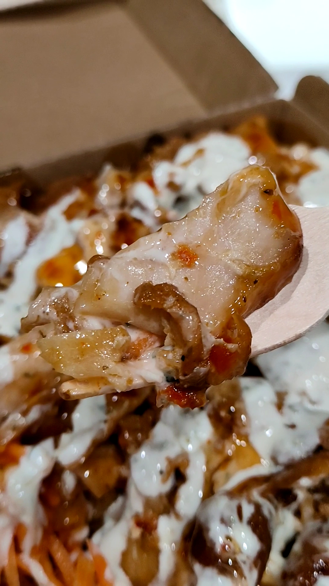 Close-up customer photo of sauced chicken and chips from Ispa Kebabs